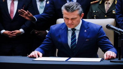 FILE PHOTO: U.S. Secretary of Defense Pete Hegseth looks at the signed joint security agreement at the inaugural Americas Counter Cartel Conference with regional defense and security leaders at U.S. Southern Command headquarters in Doral, Florida, U.S., March 5, 2026. REUTERS/Maria Alejandra Cardona