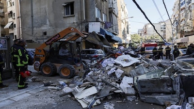 A man uses machinery to clear debris near the site of an Israeli strike on an apartment building, in central Beirut, Lebanon, March 11, 2026, following an escalation between Hezbollah and Israel amid the U.S.-Israeli conflict with Iran. REUTERS/Emilie Madi