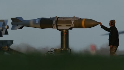 A member of ground crew moves munitions towards a USAF B1 B bomber at RAF Fairford airbase, used by USAF personnel, amid the U.S.–Israeli conflict with Iran, in Fairford, Gloucestershire, Britain, March 11, 2026. REUTERS/Phil Noble