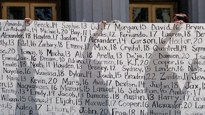 Parents who say they have lost their children due to social media hold up a banner with the names of the children outside the court after the jury found Meta and Google liable in a key test case accusing Meta and Google's YouTube of harming children's mental health through addictive social media platforms, in Los Angeles, California, U.S., March 25, 2026. REUTERS/Mike Blake     TPX IMAGES OF THE DAY