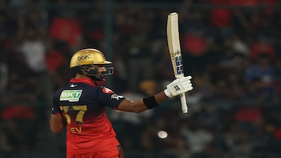 Cricket - Indian Premier League - IPL - Royal Challengers Bengaluru v Sunrisers Hyderabad - M. Chinnaswamy Stadium, Bengaluru, India - March 28, 2026 Royal Challengers Bengaluru's Devdutt Padikkal celebrates after reaching his half century REUTERS/Priyanshu Singh