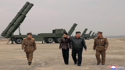 In this photo provided by the North Korean government, its leader Kim Jong Un, center right, and his daughter, center left, attend a live-fire test of multiple rocket launch systems, at an undisclosed place in North Korea Saturday, March 14, 2026. Independent journalists were not given access to cover the event depicted in this image distributed by the North Korean government. The content of this image is as provided and cannot be independently verified. Korean language watermark on image as provided by source reads: "KCNA" which is the abbreviation for Korean Central News Agency. (Korean Central News Agency/Korea News Service via AP)