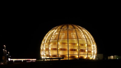 FILE - The globe of the European Organization for Nuclear Research, CERN, is illuminated outside Geneva, Switzerland, March 30, 2010. (AP Photo/Anja Niedringhaus, File)
