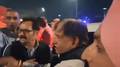 Kamal Singh Jamwal, center, who allegedly fired a shot targeting National Conference president Farooq Abdullah and Jammu and Kashmir Deputy Chief Minister Surinder Choudhary at a wedding function, being detained by people before being handed over to security personnel, in Jammu. (PTI)