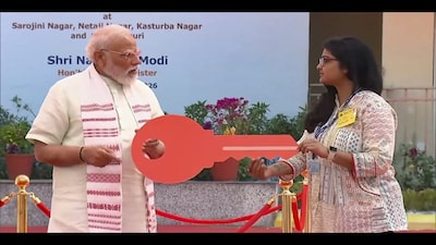**EDS: THIRD PARTY IMAGE** In this screengrab from a video posted on March 8, 2026, Prime Minister Narendra Modi hands over a key to a woman at GPRA Type-5 quarters, in Sarojini Nagar, New Delhi. (@NarendraModi/YT via PTI Photo)(PTI03_08_2026_000149B)