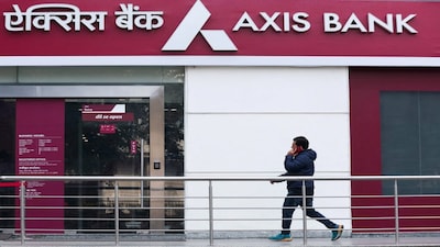 FILE PHOTO: A man walks outside a branch of Axis Bank in New Delhi, India, January 29, 2024. REUTERS/Anushree Fadnavis/File Photo