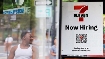 A 7-Eleven convenience store has a sign in the window reading "Now Hiring" in Cambridge, Massachusetts, U.S., July 8, 2022. REUTERS/Brian Snyder