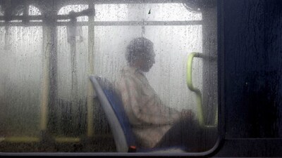 A commuter travels in a bus during a heavy monsoon rain shower in New Delhi. (Image Reuters file 