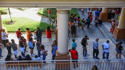 People wait in line to vote at a polling station during the general election in Rio de Janeiro, Brazil, October 4, 2026. REUTERS/Pilar Olivares