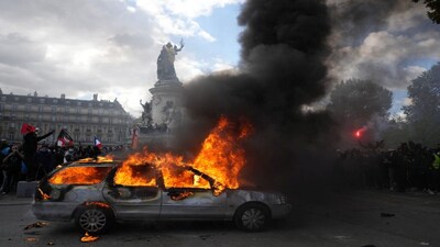 A car burns at Republique square during a protest against rising living costs, joining students' grievances, in Paris, Saturday, Oct. 17, 2026. (AP Photo/Thibault Camus)