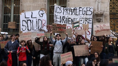 French high school students gather outside the Lycee Louis-le-Grand high school in Paris as part of a nationwide day of demonstrations