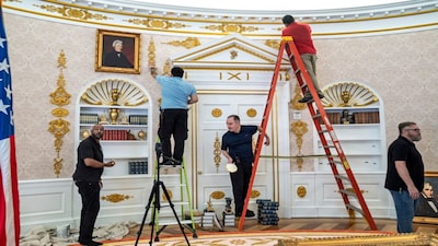 A replica of President Donald Trump's Oval Office is updated to the current decor by workers at "The People's House: A White House Experience," in Washington, Friday, Oct. 2, 2026. (AP Photo/J. Scott Applewhite)