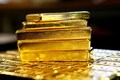 Gold prices ease as US rate hike views, trade tensions boost dollar