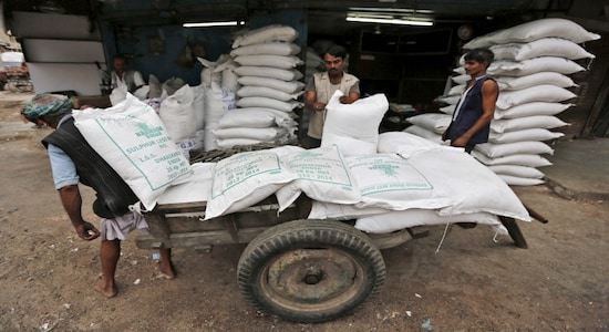 Workers unload sacks containing sugar from a handcart at a wholesale market in Ahmedabad Workers unload sacks containing sugar from a handcart at a wholesale market in Ahmedabad