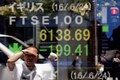 World stock markets fall on trade fears and rate hike worries