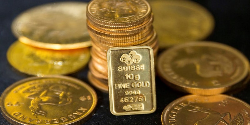 Gold prices drop marginally as dollar ticks higher