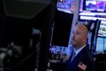 Wall Street falls after Fed statement, energy shares tumble