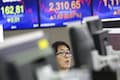 Asian shares dip on mixed US earnings, euro off two-year low as ECB holds
