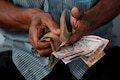 Rupee edges higher in opening trade on easing oil prices