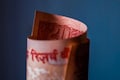Rupee falls against US dollar after Moody's cuts India rating outlook