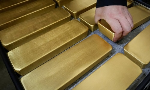 Gold dips 1% as equities firm, but eyes third weekly gain