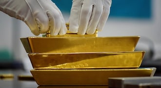 Gold holds near six-year peak as trade tensions simmer