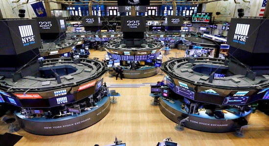 FILE - In this Oct. 18, 2017, file photo, traders work on the floor of the New York Stock Exchange. The bull market in stocks started with the U.S. still reeling from the Great Recession in March 2009. The bull turns 10 this weekend, having survived threats such as a debt crisis in Europe (2011), a slowdown in the Chinese economy (2015-2016), and fears of inflation and rising interest rates in the U.S. (AP Photo/Richard Drew, File)