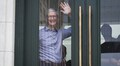 At Apple's new store opening, CEO Tim Cook poses for selfies with customers