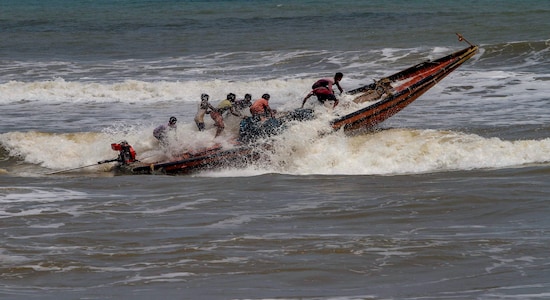 Puri: Fishermen try to control their boat amidst rough sea waters at Puri beach, Tuesday, April 30 2019. Cyclone 'Fani' in is likely to intensify into an 'extremely severe cyclonic storm' by late night and can hit the Odisha coast by Friday afternoon, the India Meteorological Department said