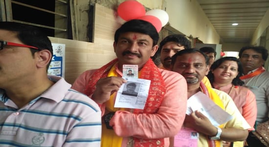 Manoj Tiwari queues to cast his vote at a Yamuna Vihar polling booth.