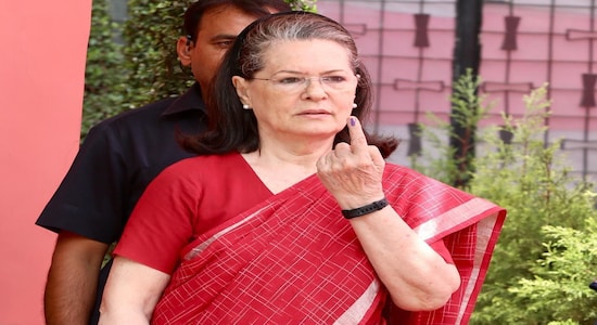 Sonia Gandhi shows her inked finger after casting vote.