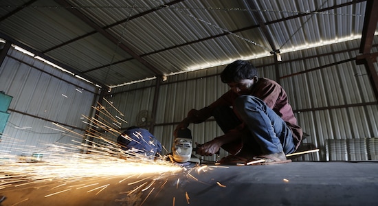 A worker welds together a water tanker at a local manufacturing workshop in Bangalore, India on March 12, 2019. Thomson Reuters Foundation/Rajan Zaveri