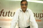 What prompted Kishore Biyani to sell his business to RIL
