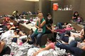 'Help, 40 days here': Photos show migrants crammed into US border facilities