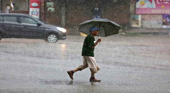 A pedestrian walks with an umbrella in the rain in Jammu, India, Saturday, July 27, 2019. The monsoon season in India lasts from June to September. (AP Photo/Channi Anand)