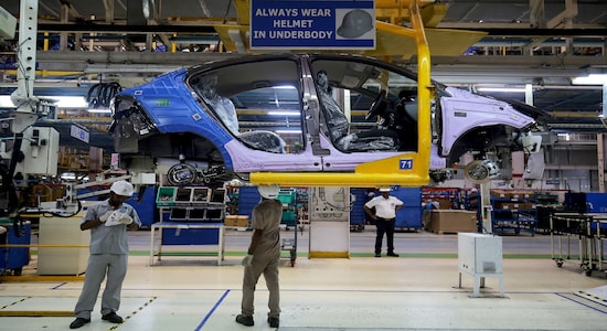 Workers assemble a Tata Tigor car inside the Tata Motors car plant in Sanand, on the outskirts of Ahmedabad