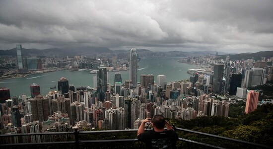 In this Sunday, Sept. 1, 2019 photo, a man sets up his camera in the Victoria Peak area to photograph Hong Kong's skyline. Life is not quite normal after three months of steady protests in the Asian financial center - and yet normal life goes on, as it must, for the city’s 7.4 million residents. (AP Photo/Jae C. Hong) In this Sunday, Sept. 1, 2019 photo, a man sets up his camera in the Victoria Peak area to photograph Hong Kong's skyline. Life is not quite normal after three months of steady protests in the Asian financial center - and yet normal life goes on, as it must, for the city’s 7.4 million residents. (AP Photo/Jae C. Hong)