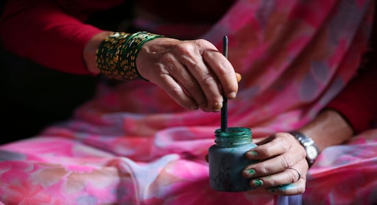 In this July 31, 2019, photo, Tej Kumari Chitrakar mixes color to make traditional paintings ahead of Naag Panchami festival at her residence in Bhaktapur, Nepal. Chitrakar families in the Nepalese capital of Kathmandu were renowned traditional painters and sculptors who depicted gods and goddesses on temples, masks of Hindu deities and posters for various religious celebrations. For Tej Kumari and her husband it is a struggle to keep the dying art alive against the modern mass produced prints. (AP Photo/Niranjan Shrestha) In this July 31, 2019, photo, Tej Kumari Chitrakar mixes color to make traditional paintings ahead of Naag Panchami festival at her residence in Bhaktapur, Nepal. Chitrakar families in the Nepalese capital of Kathmandu were renowned traditional painters and sculptors who depicted gods and goddesses on temples, masks of Hindu deities and posters for various religious celebrations. For Tej Kumari and her husband it is a struggle to keep the dying art alive against the modern mass produced prints. (AP Photo/Niranjan Shrestha)