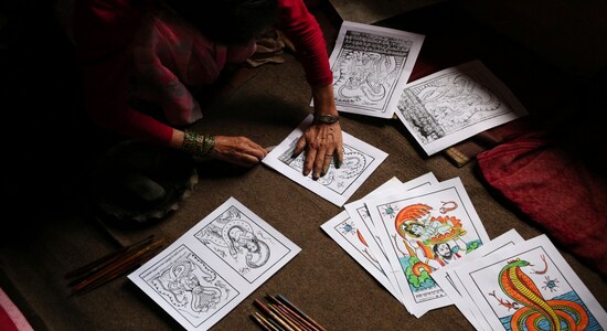 In this July 31, 2019, photo, Tej Kumari Chitrakar makes traditional paintings ahead of Naag Panchami festival at her residence in Bhaktapur, Nepal. Chitrakar families in the Nepalese capital of Kathmandu were renowned traditional painters and sculptors who depicted gods and goddesses on temples, masks of Hindu deities and posters for various religious celebrations. For Tej Kumari and her husband it is a struggle to keep the dying art alive against the modern mass produced prints. (AP Photo/Niranjan Shrestha) In this July 31, 2019, photo, Tej Kumari Chitrakar makes traditional paintings ahead of Naag Panchami festival at her residence in Bhaktapur, Nepal. Chitrakar families in the Nepalese capital of Kathmandu were renowned traditional painters and sculptors who depicted gods and goddesses on temples, masks of Hindu deities and posters for various religious celebrations. For Tej Kumari and her husband it is a struggle to keep the dying art alive against the modern mass produced prints. (AP Photo/Niranjan Shrestha)