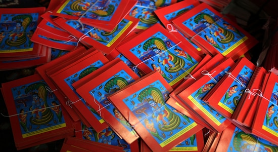 This July 29, 2019, photo shows machine printed posters prepared ahead of the Naag panchami festival at a store in Kathmandu, Nepal. The art and tradition of Nepal’s Chitrakar families, who depicted gods and goddesses on temples, masks of Hindu deities and posters for various religious celebrations is dying because of mass machine printed posters and card-size pictures of gods that are cheaper and more popular. (AP Photo/Niranjan Shrestha) This July 29, 2019, photo shows machine printed posters prepared ahead of the Naag panchami festival at a store in Kathmandu, Nepal. The art and tradition of Nepal’s Chitrakar families, who depicted gods and goddesses on temples, masks of Hindu deities and posters for various religious celebrations is dying because of mass machine printed posters and card-size pictures of gods that are cheaper and more popular. (AP Photo/Niranjan Shrestha)
