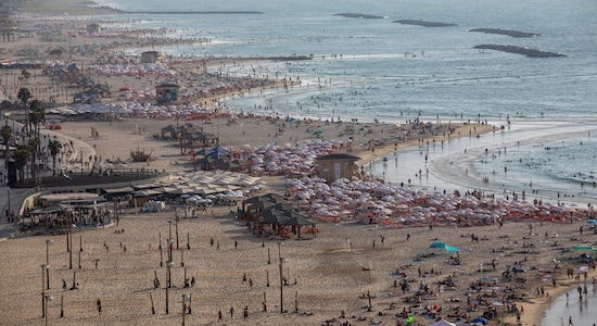 People enjoy the Mediterranean Sea beachfront during the Jewish holiday of Sukkot, in Tel Aviv, Israel, Monday, Oct. 14, 2019. (AP Photo/Oded Balilty)