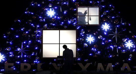 In this Wednesday, Nov. 20, 2019, file photo, a man looks at a Christmas display showing the silhouette of a Santa Claus figure Wednesday, Nov. 20, 2019, in Tokyo. (AP Photo/Jae C. Hong, File)