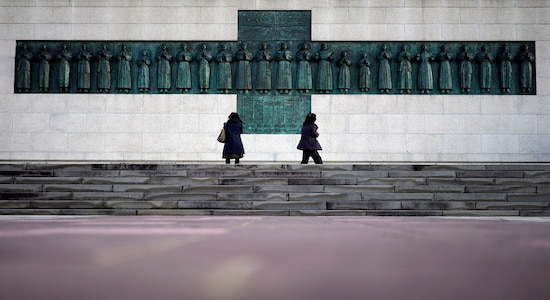In this Nov. 17, 2019, file photo, people visit the Twenty-Six Martyrs Monument in Nagasaki, southern Japan. Pope Francis will start his first official visit to Japan in Nagasaki, ground zero for the Christian experience in a nation where the Catholic leader once dreamed of living as a missionary. (AP Photo/Eugene Hoshiko, File)