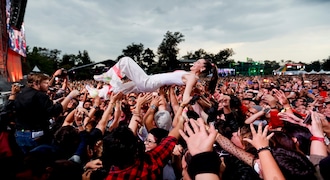 In this photo from Sunday, November 17, 2019, Sophie Hawley-Weld of German-American musical duo Sofi Tukker surfs with fans during the Corona Capital music festival in Mexico City.  (AP Photo / Eduardo Verdugo)