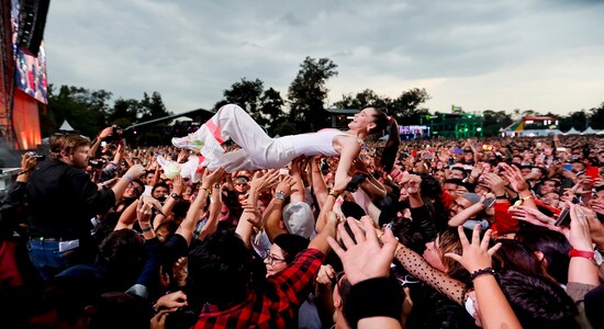 In this Sunday, Nov. 17, 2019 photo, Sophie Hawley-Weld, of German-American musical duo Sofi Tukker, crowd surfs with fans during the Corona Capital music festival in Mexico City. (AP Photo/Eduardo Verdugo)