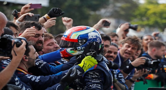 In this Sunday, Nov. 17, 2019 photo, Toro Rosso driver Pierre Gasly, of France, celebrates after getting the second place in the Brazilian Formula One Grand Prix at the Interlagos race track in Sao Paulo, Brazil. (AP Photo/Nelson Antoine)
