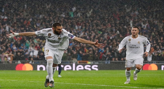 Real Madrid's Karim Benzema, left, celebrates after scoring his side's opening goal during a Champions League soccer match Group A between Real Madrid and Paris Saint Germain at the Santiago Bernabeu stadium in Madrid, Spain, Tuesday, Nov. 26, 2019. (AP Photo/Manu Fernandez)