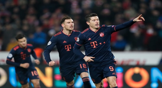 Bayern's Robert Lewandowski, right, celebrates after scoring his side's second goal from the penalty spot during the Champions League group B soccer match between Red Star and FC Bayern Munich at the Rajko Mitic Stadium, in Belgrade, Serbia, Tuesday, Nov. 26. (AP Photo/Darko Vojinovic)