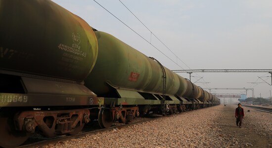 A boy walks past an oil tanker train stationed at a railway station in Ghaziabad, on the outskirts of New Delhi, February 1, 2019. REUTERS/Anushree Fadnavis/File Photo