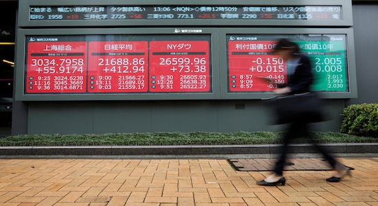 A woman walks past an electric screen showing world markets indices outside a brokerage in Tokyo, Japan, July 1, 2019. REUTERS/Issei Kato A woman walks past an electric screen showing world markets indices outside a brokerage in Tokyo, Japan, July 1, 2019. REUTERS/Issei Kato